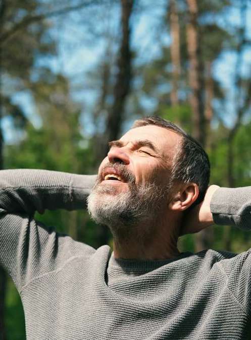 Elderly man looking looking up at sky